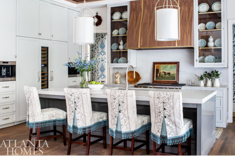We don’t know if we’ll ever stop loving a classic white kitchen, but we’re glad color is creeping back into the heart of the home. Especially when it’s a dusky blue that gets a lift from some sassily upholstered bar stools. <a href="https://www.lizgodwininteriors.com/" target="_blank">Elizabeth Godwin Interiors</a> & Kingdom Woodworks