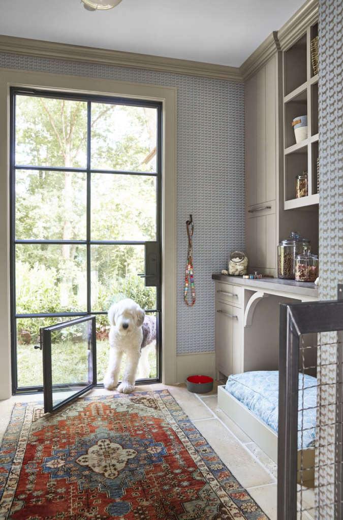 Even the pooches have a spot to call their own. This is the dog mudroom, complete with a fancy iron dog door, a shower, and a comfy bed.  (Photo: Victoria Pearson)