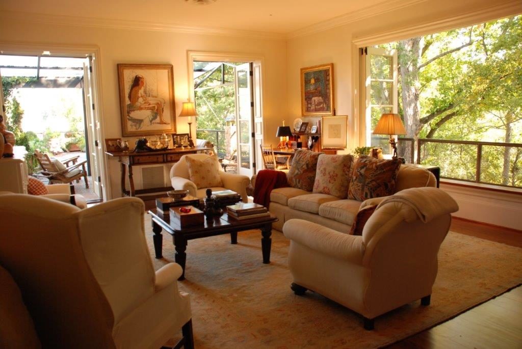 The formal living room with its French molding and beautiful windows framing the Buckhead treetops