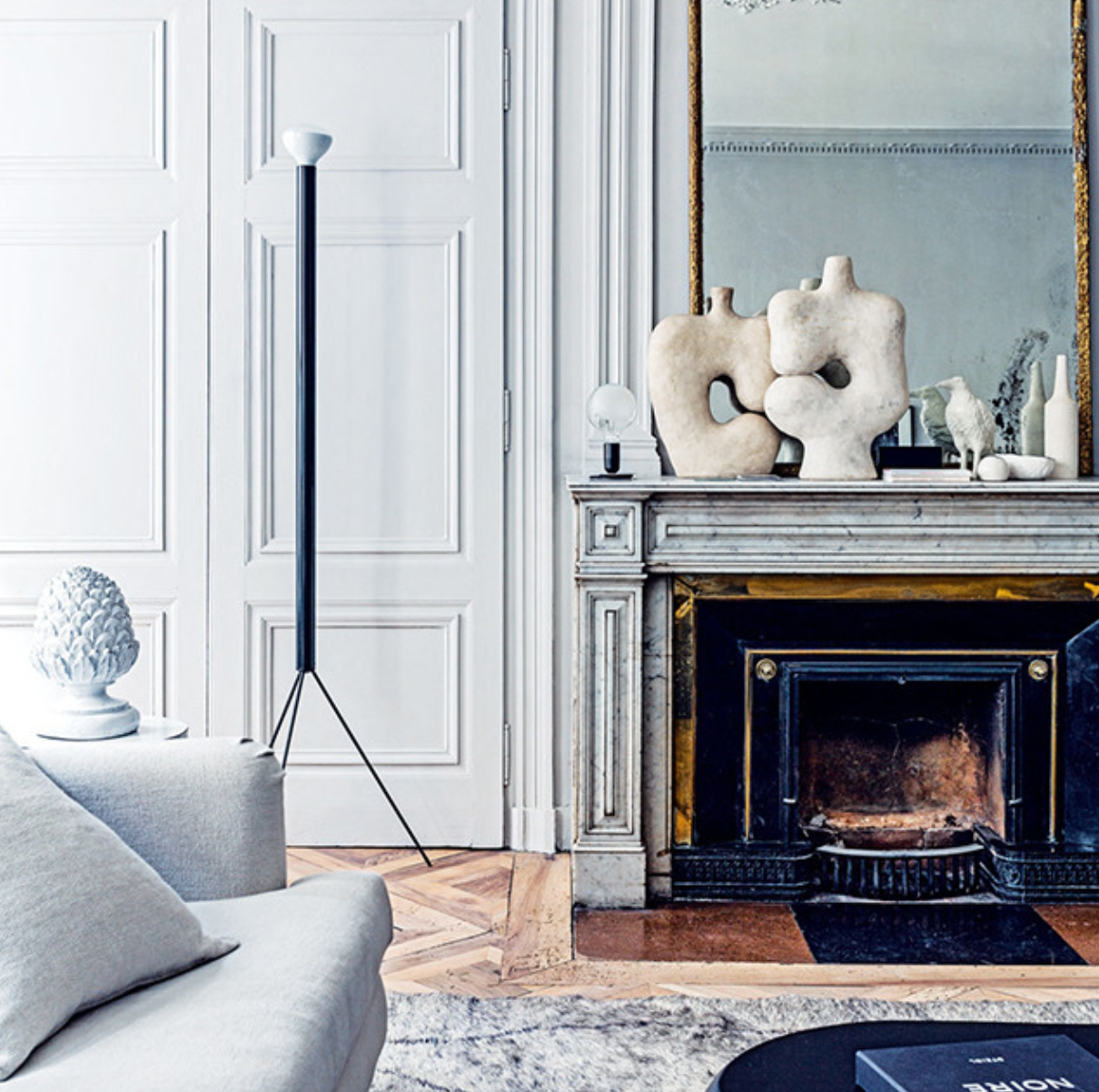More modern meets Parisian chic: texture, sculpture, a gold mirror and a period fireplace all work so beautifully together.  From <a href="http://www.designattractor.com/2016/03/magnificent-french-apartment.html" target="_blank">Design Attractor</a>.