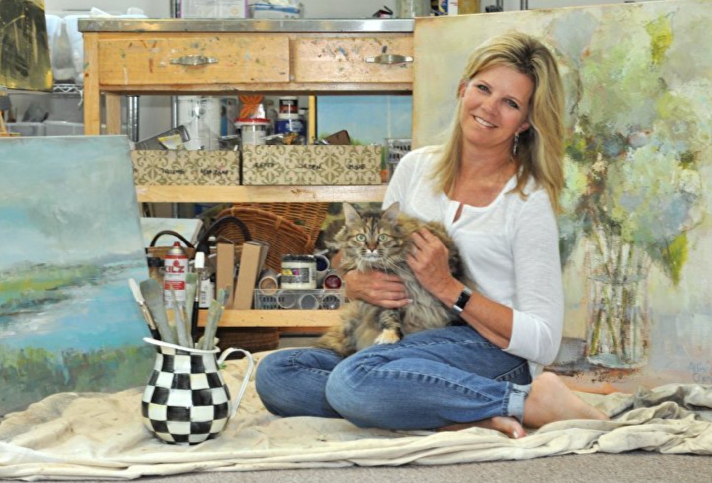 Allison and her painting buddy, Cabi at home in her studio.