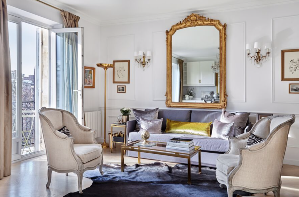 Another Paris apartment. Our go-to’s? Always a stunning Louis mirror, a sexy mid-century coffee table and a pair of elegant fauteuils – perfect for watching the Eiffel Tower do its sparkling thing. (photo: <a href="https://emilyfollowill.com/about/" target="_blank">Emily Followill</a>)