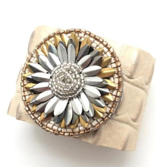 A hand-picked <a href="https://huffharrington.com/collections/jewelry/products/shiver-and-duke-flower-burst-bracelet" target="_blank">leather cuff</a> embellished with a floral design.