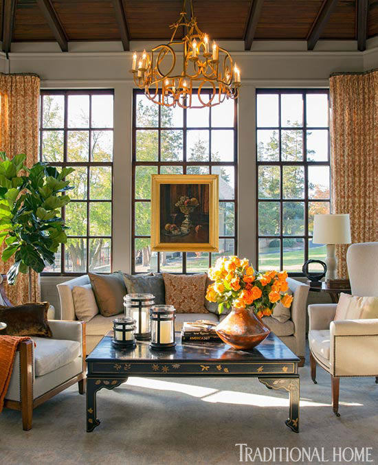 A fall-inspired room by designer Gerald Pomeroy is tied together with an artfully placed painting. Image by Eric Roth via Traditional Home.