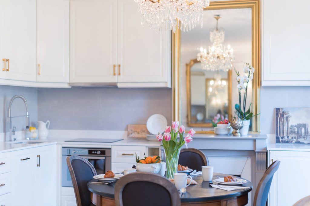 We love the reflection of the mirrors from the kitchen to the living room, and the multiplication of chandeliers in the reflection. "How to get four chandeliers? Buy one Chandie and two mirrors!"