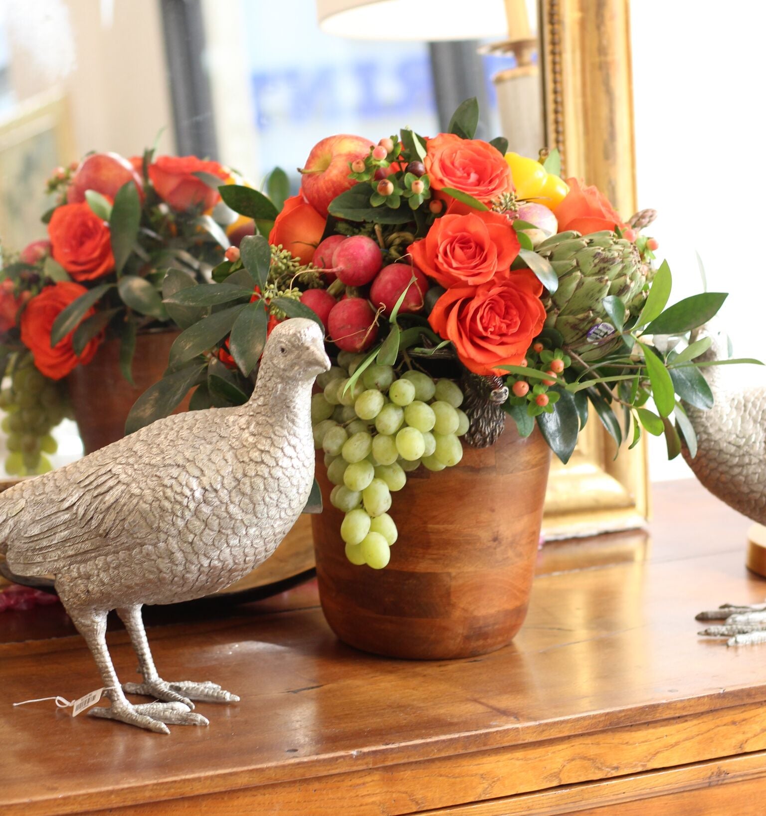 Our very own Sam Jones made this breathtaking Thanksgiving arrangement using blooms (and edibles!) in a wood ice bucket.