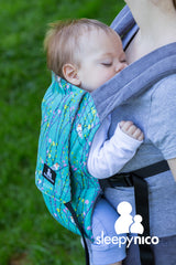 A baby asleep in a SleepyNico carrier