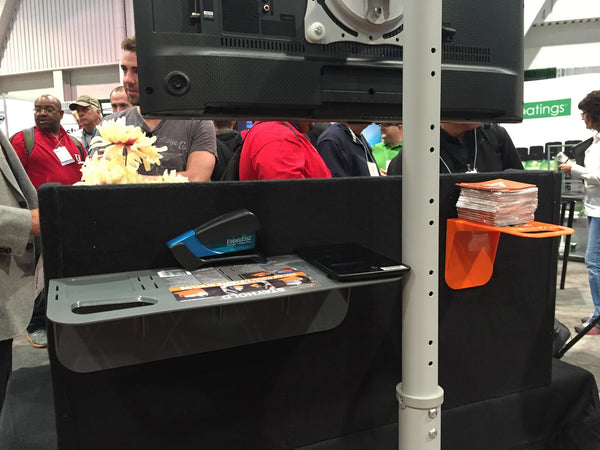 Using STAYHOLD™ Cargo Organiser as impromptu shelves at a tradeshow