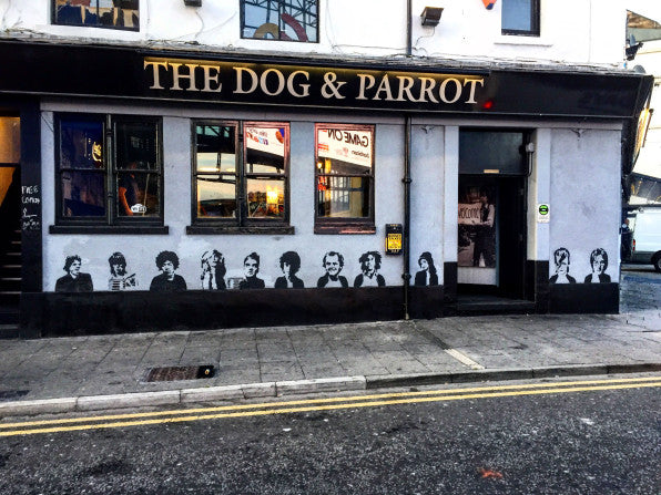 exterior of pub painted with stencils of famous faces