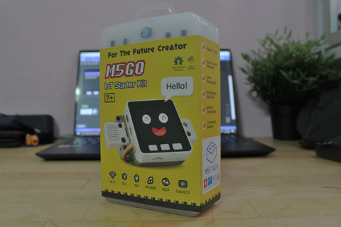 Product shot of M5GO, colorful yellow box with cute robot mascot
