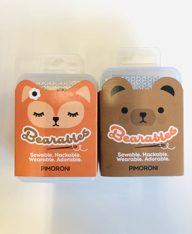 Cute orange cartoon fox and adorable brown bear packaging on plastic box against a white background