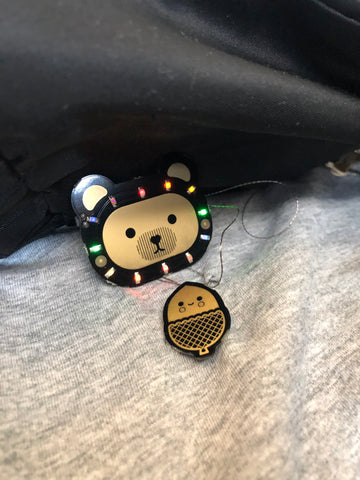 colourful light on cute bear badge and acorn-shaped component