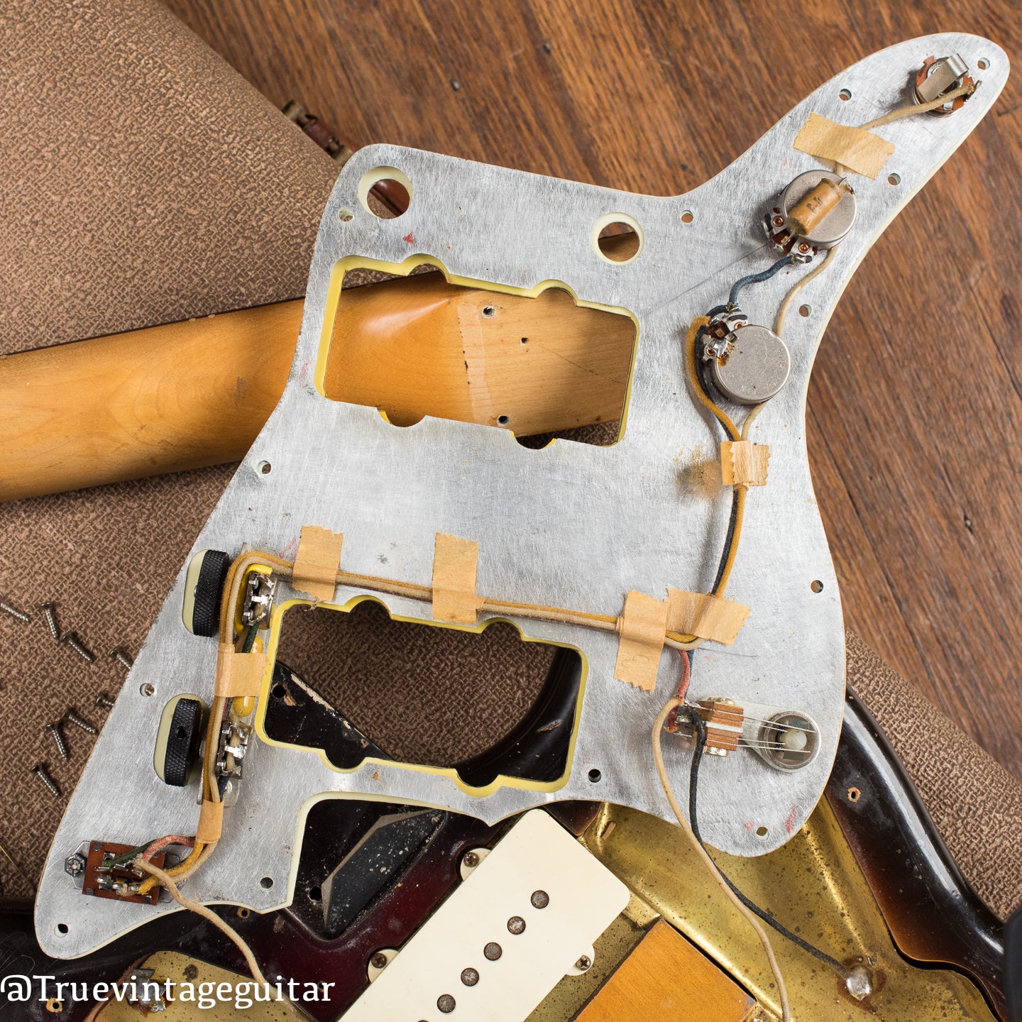 Under pickguard, original electronics, potentiometers, vintage 1960 Fender Jazzmaster electric guitar