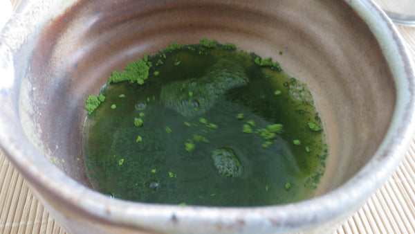 Photo of warm water with matcha in the chawan.