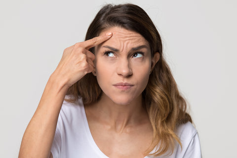 woman touching forehead