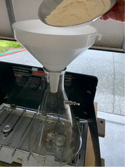 Adding DME with a funnel for yeast starter