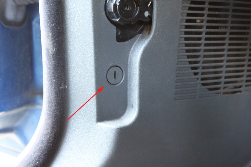 Plug under hood release lever indicated with arrow.