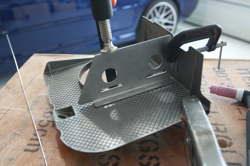 Fitment of Turner Motorsport S52 Oil Pan Baffle Kit. New pieces being clamped in place.