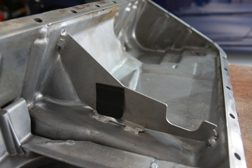 Turner Motorsport S52 oil pan baffle with rubber flaps installed.