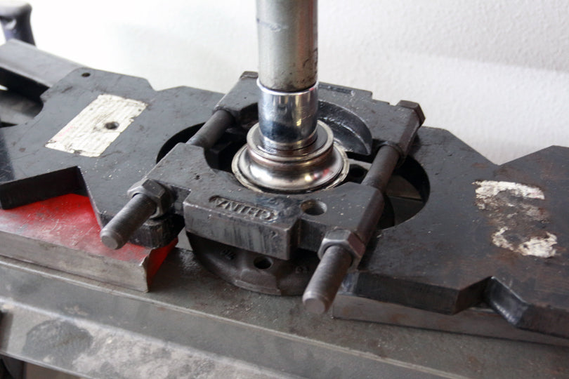 Bearing separator being used to pull the inner race of the bearing off the hub.