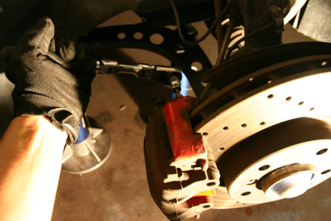 Loosening caliper guide pin bolts.