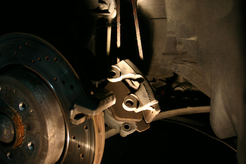 Brake caliper suspended by a rope.