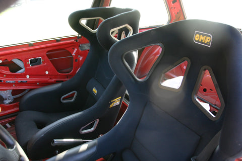 Driver's and passenger race seats inside cockpit.