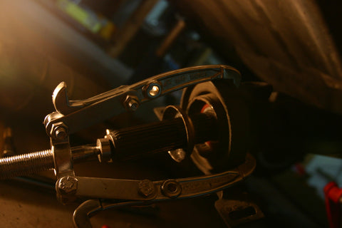 Three-jaw puller attempting to remove the center support bearing.