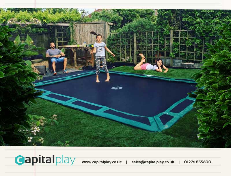 Kids playing on in-ground trampoline