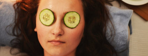 Woman with cucumbers on eyes