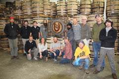 The staff at high West lineup for a photo op with the repurposed barrel logo provided by Material Resourcers. Photo courtesy: Benjamin Siler