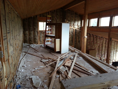 The interior is stripped of drywall, wiring and plumbing is removed, and lumber is strategically removed. 