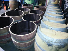 Wine barrels halves ready to be placed on pallets.  We can handle large orders!