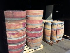 Wine barrel halves sitting on pallets, ready to be picked up and shipped!  We can handle your bulk order, too!
