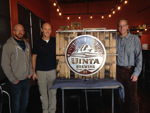 Large image of repurposed whiskey barrel piece presented to Uinta Brewing Company (L to R: Bryce hart (Innovative Metal Works), Daniel Salmon (Owner - Material Resourcers), Will Hamill (Founder - Uinta Brewing Company