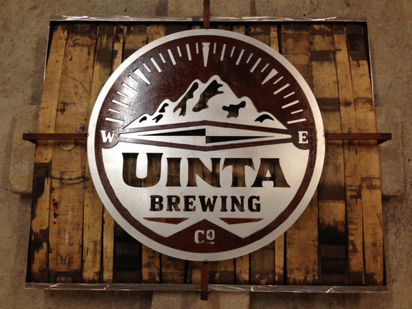 Large close up of repurposed whiskey barrel art piece using logo from Uinta Brewing company