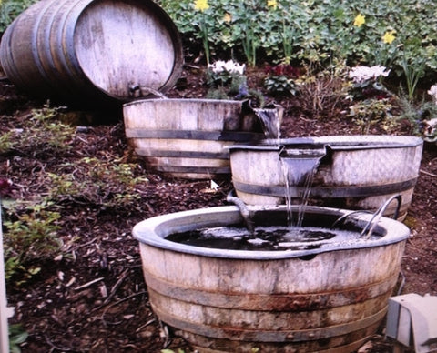 Oak whiskey barrels repurposed as waterfall for backyard