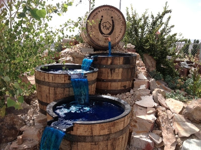 Reclaimed High West whiskey barrels repurposed as backyard waterfall