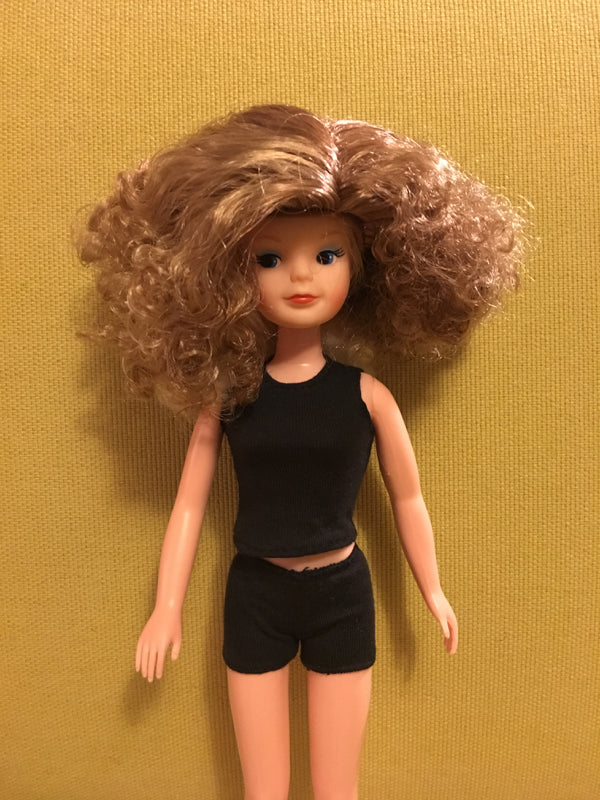 Smirky Sindy wearing curly blonde wig.