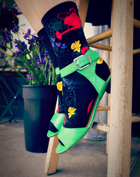 Colorful floral socks worn with green sandals