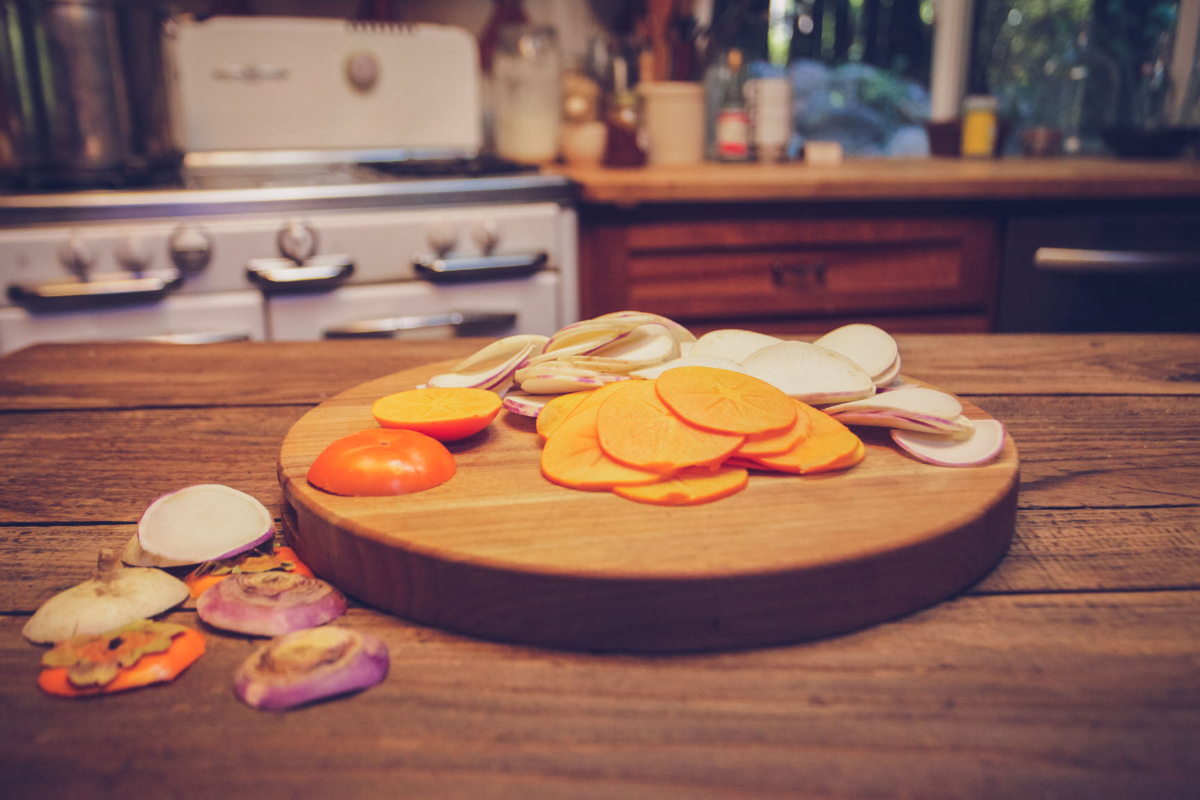 A 2 part image showing peeled turnips being sliced on a mandoline