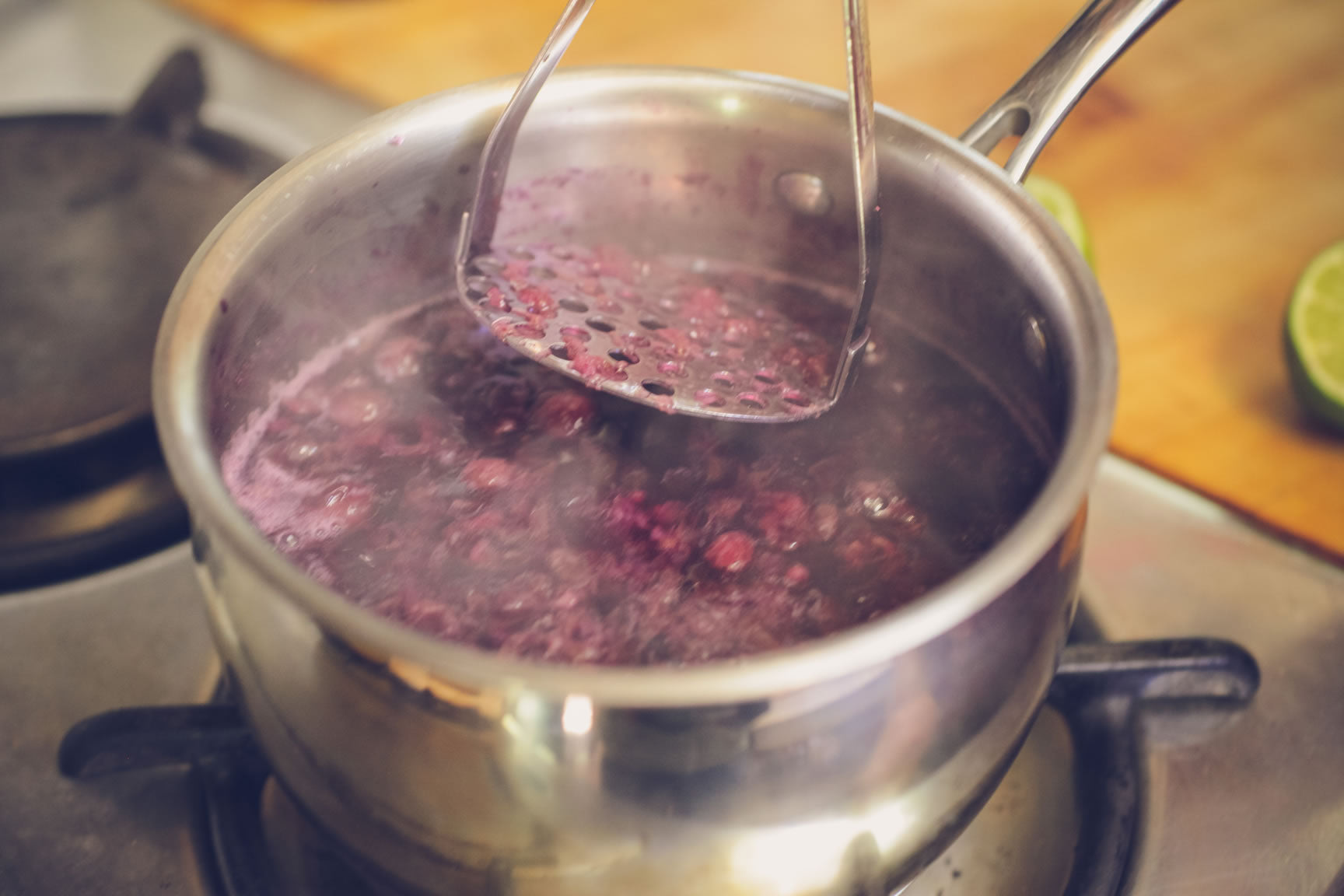 mash berries while cooking