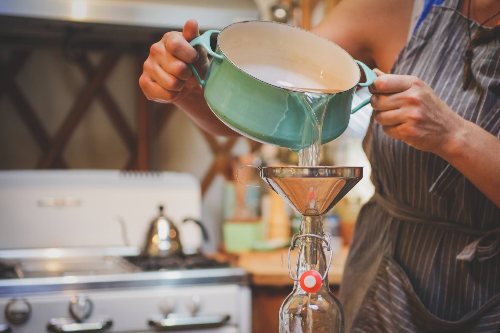 decanting orange bitters into storage bottles, how to make bitters