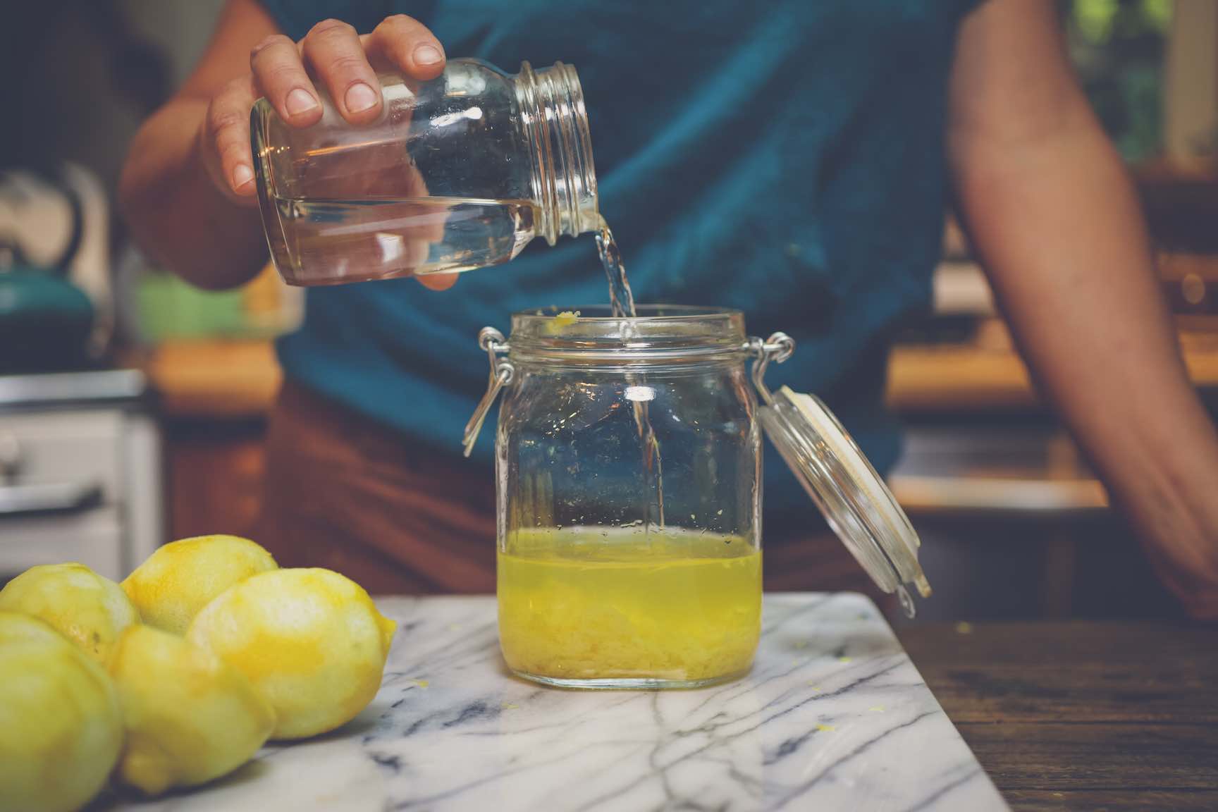 infusing vodka with lemon zest to make limoncello