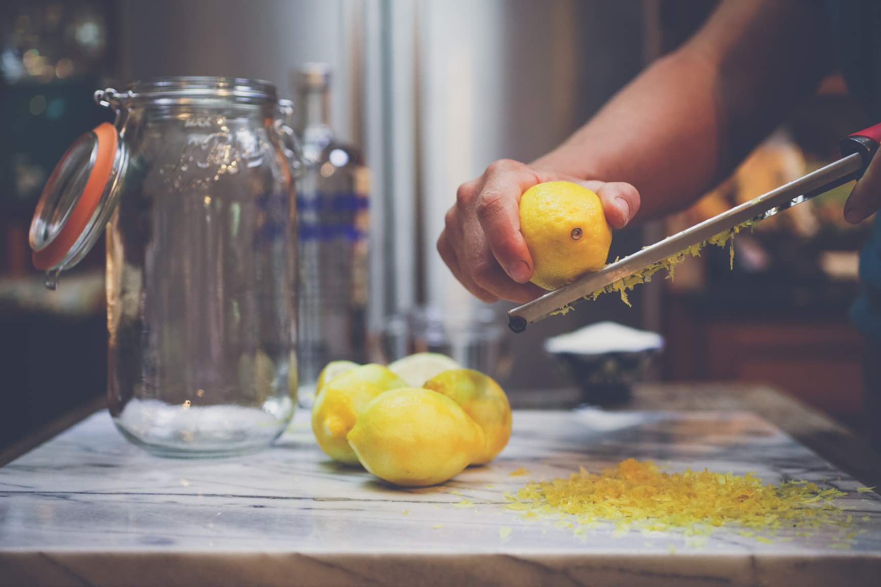zesting lemons for homemade limoncello