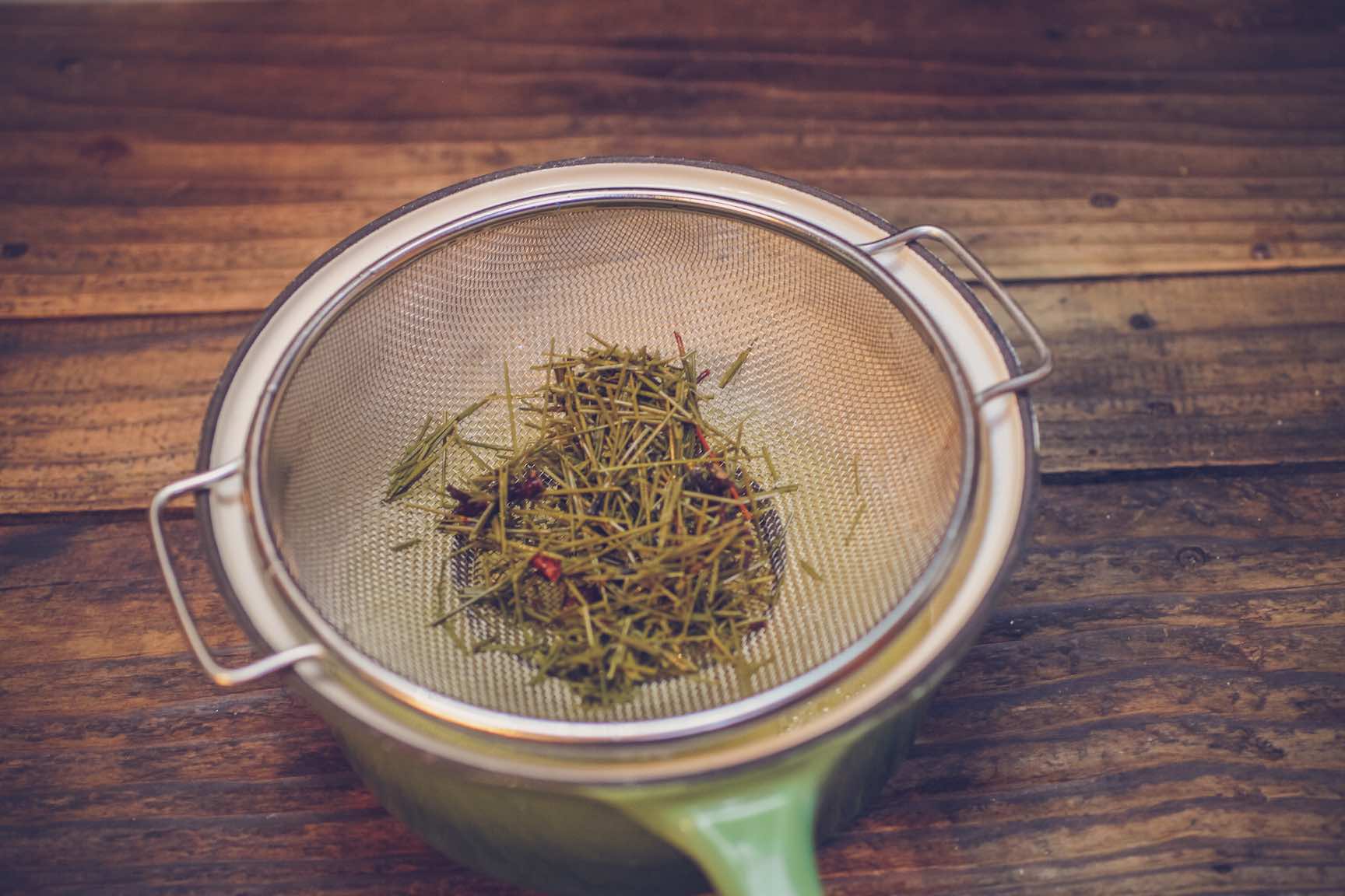 making tree pine needle simple syrup for homemade old fashioned cocktail