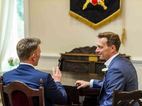 picture of best man and groom talking at a wedding
