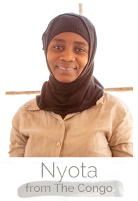 Nyota a Congolese woman makes handcrafted soy blend fair trade candles at Prosperity Candle