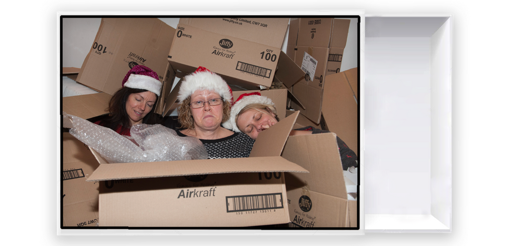 three helpers with empty packing boxes