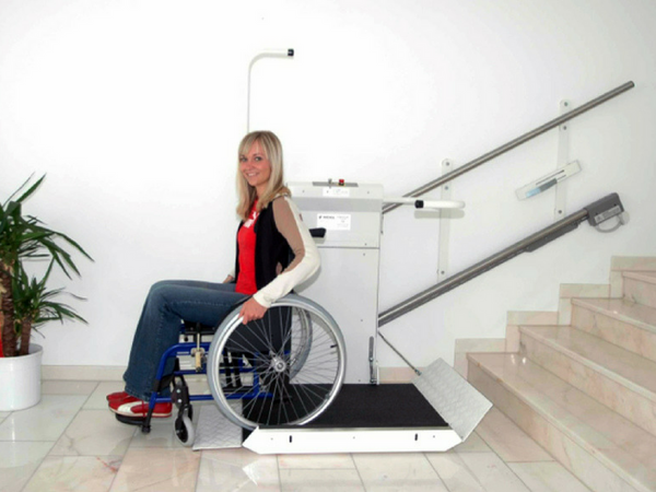 Image of woman on a wheelchair stair lift